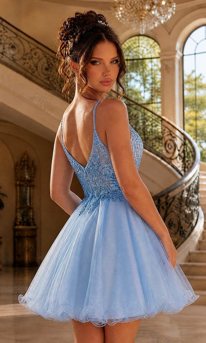 A woman in a Beaded-Bodice Short Prom Dress with Rolled Hem stands in front of a curved staircase in an elegant interior with large windows.